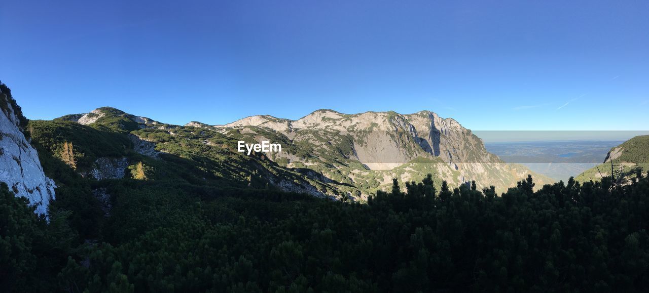 Scenic view of mountains against clear blue sky