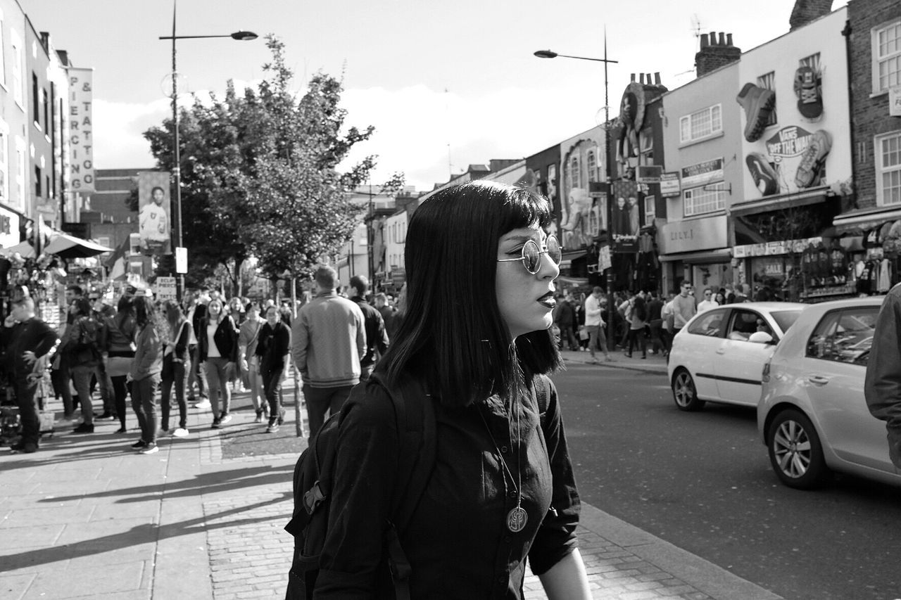 PANORAMIC VIEW OF PEOPLE STANDING ON ROAD