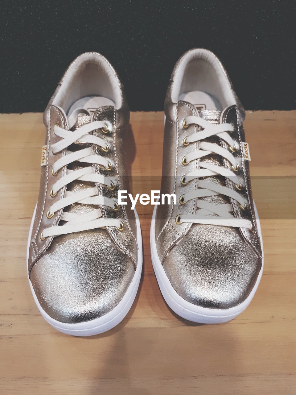 HIGH ANGLE VIEW OF SHOES AND HARDWOOD FLOOR