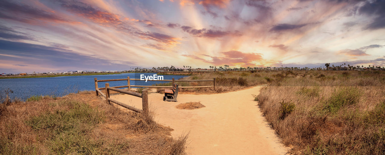 Bench overlooking the marsh of bolsa chica wetlands in huntington beach, california, usa