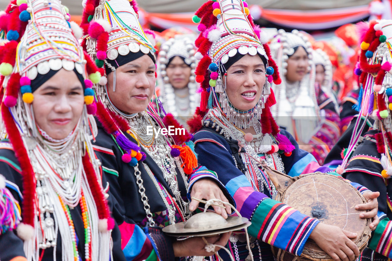 GROUP OF PEOPLE LOOKING AT TRADITIONAL CLOTHING