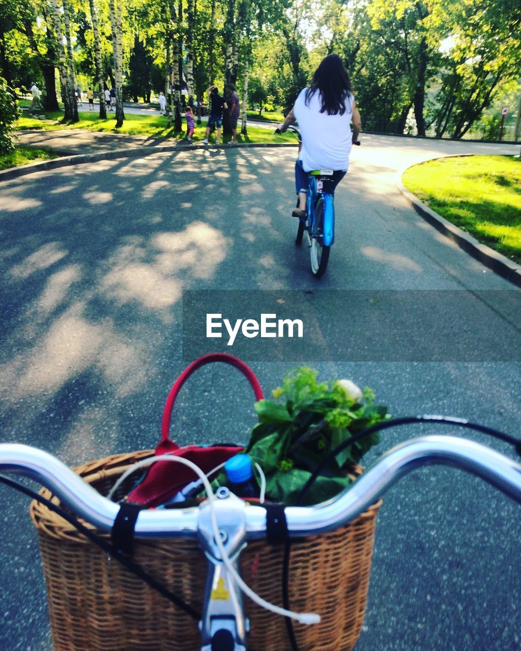 Rear view of bicycling on road