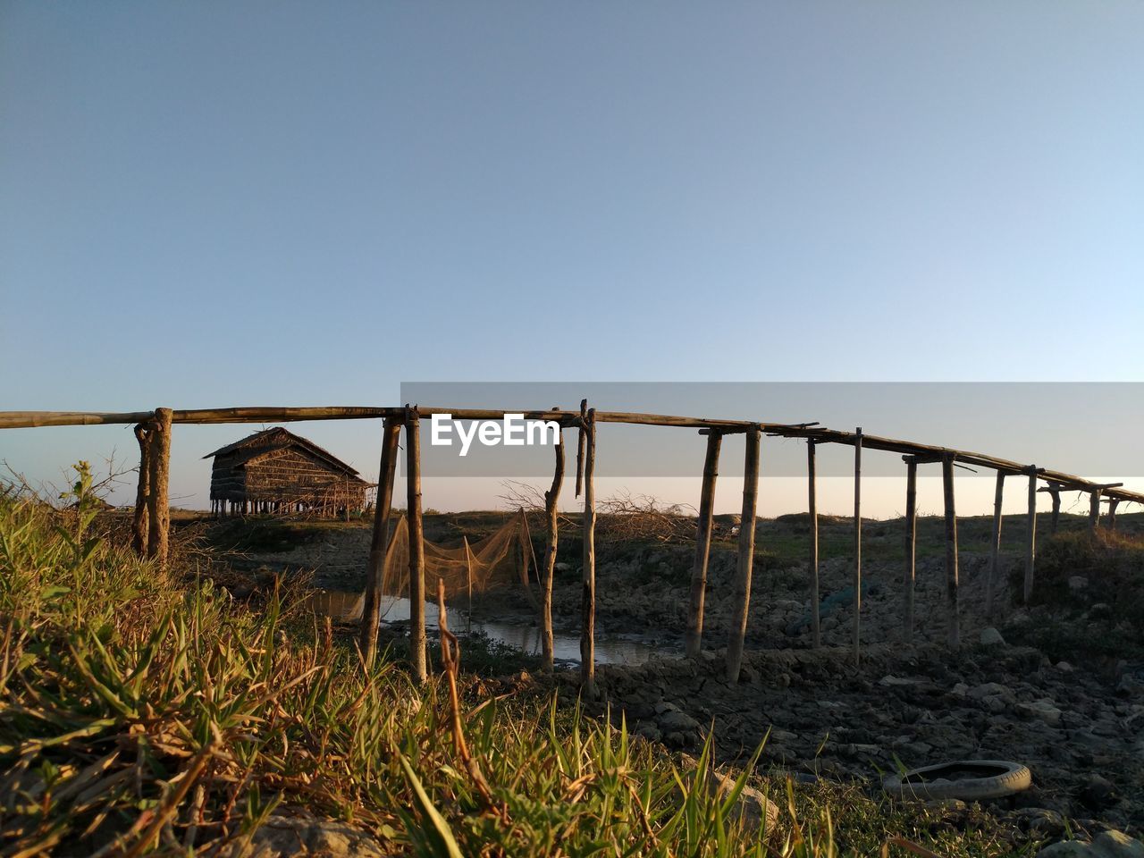 ABANDONED BUILT STRUCTURE ON FIELD AGAINST SKY