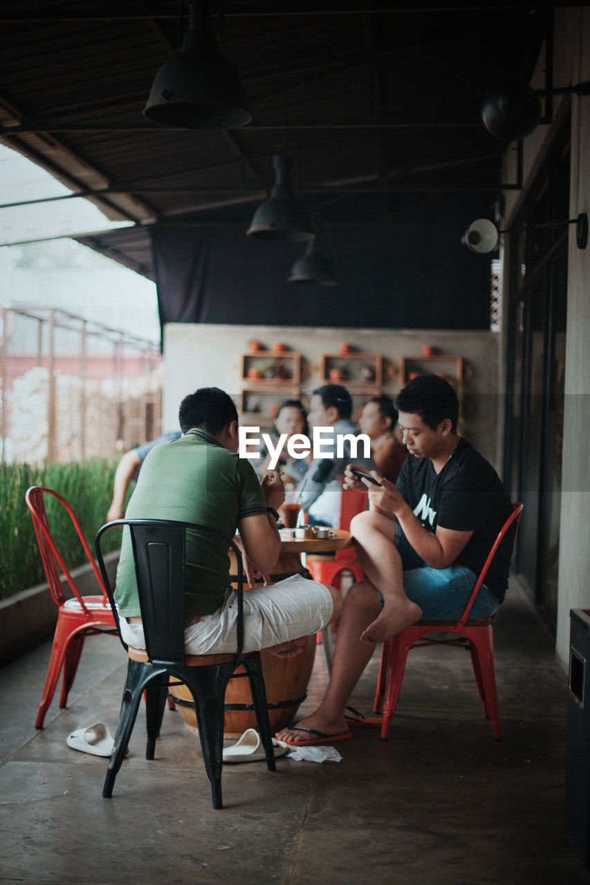 PEOPLE SITTING ON CHAIR IN OFFICE