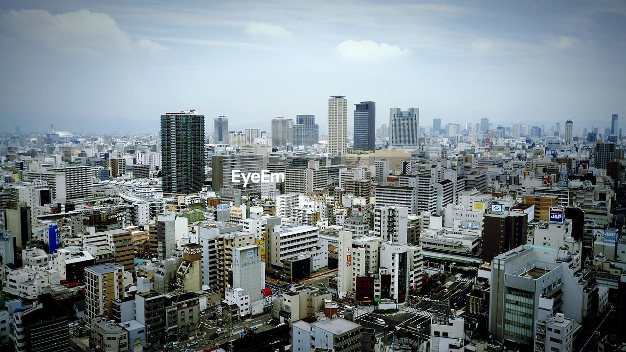 Crowded cityscape against sky