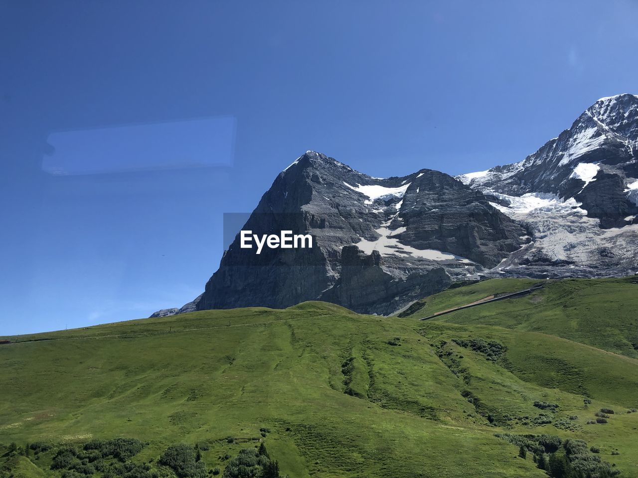 Scenic view of mountains against clear blue sky