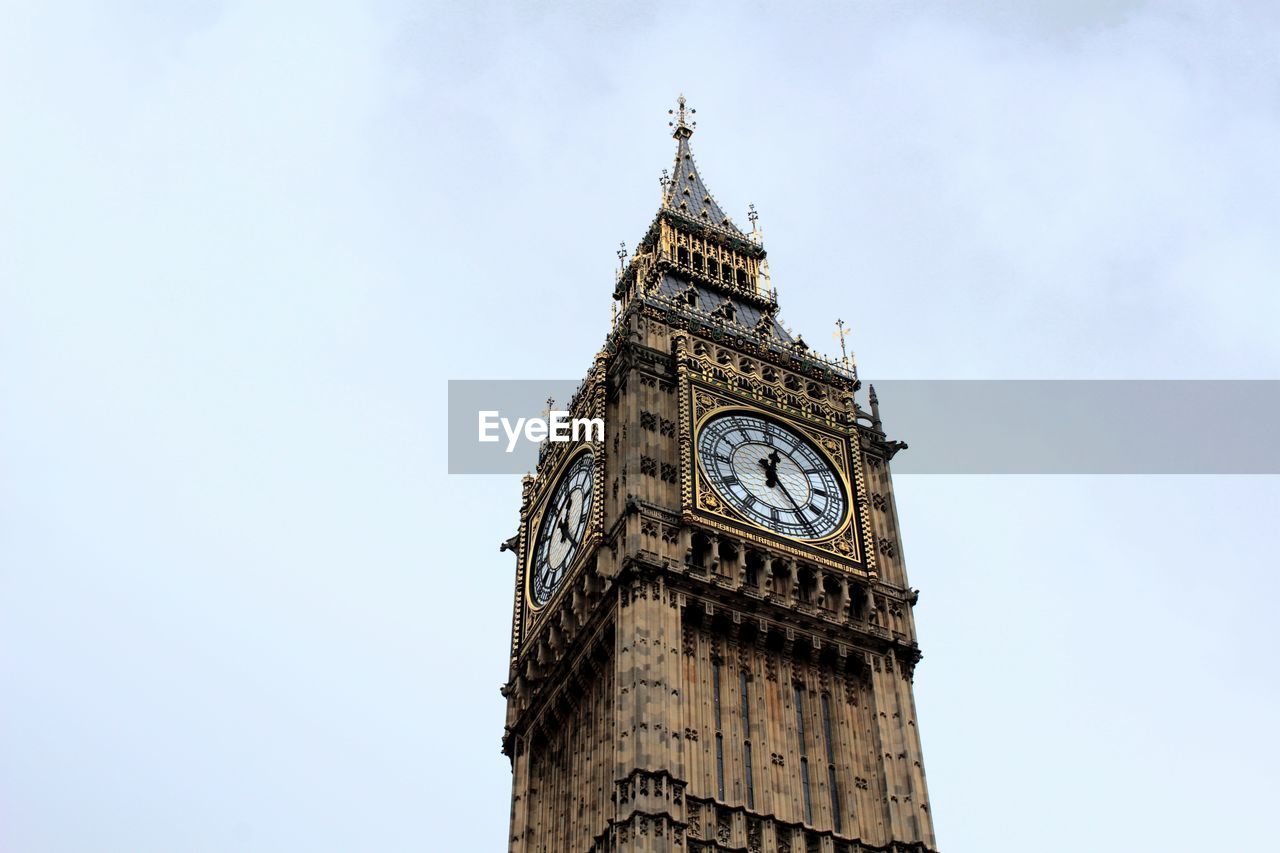 Low angle view of big ben against blue sky