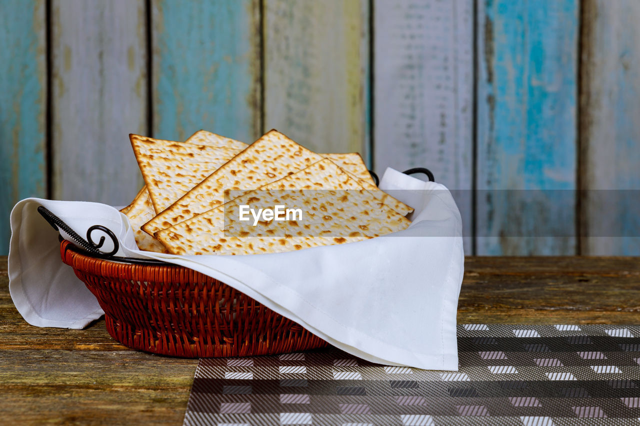 Close-up of crackers in wicker basket on table