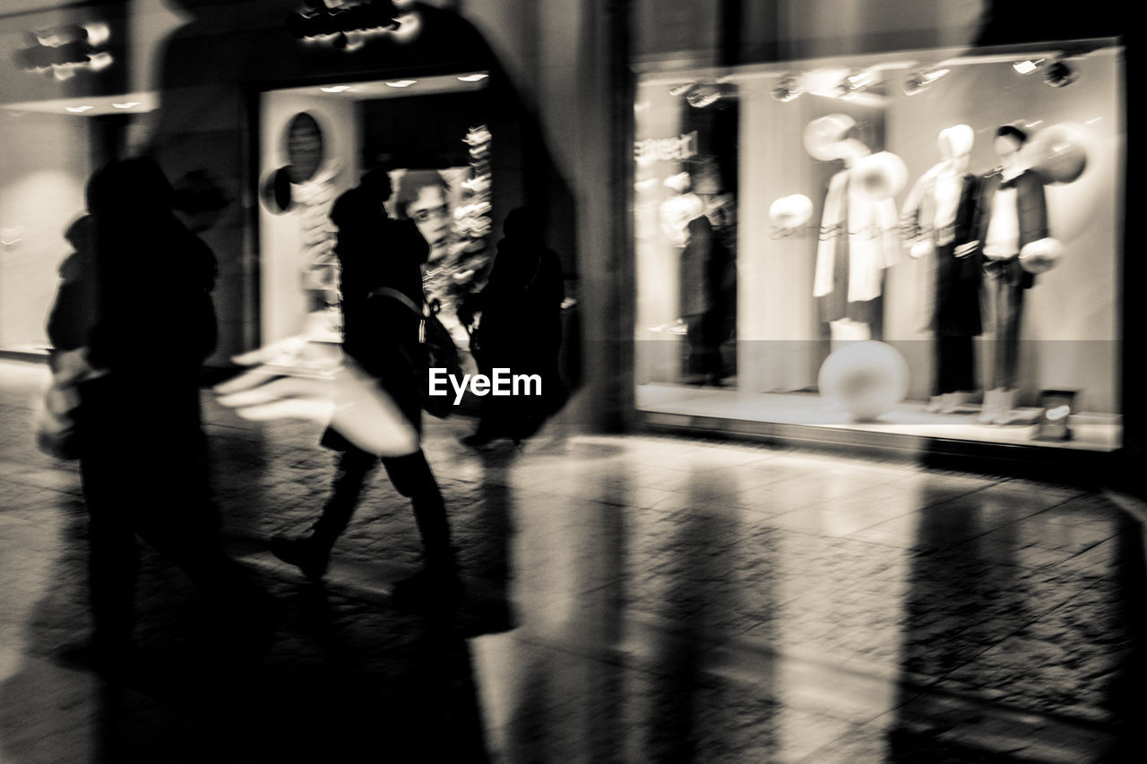 Blurred motion of women walking in city