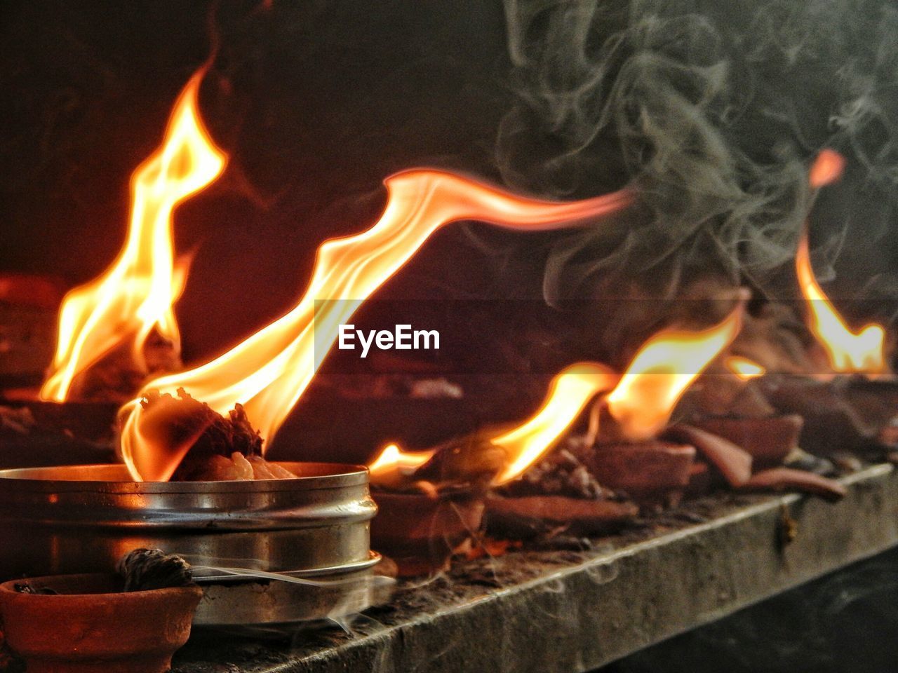 Close-up of fire burning at a temple 