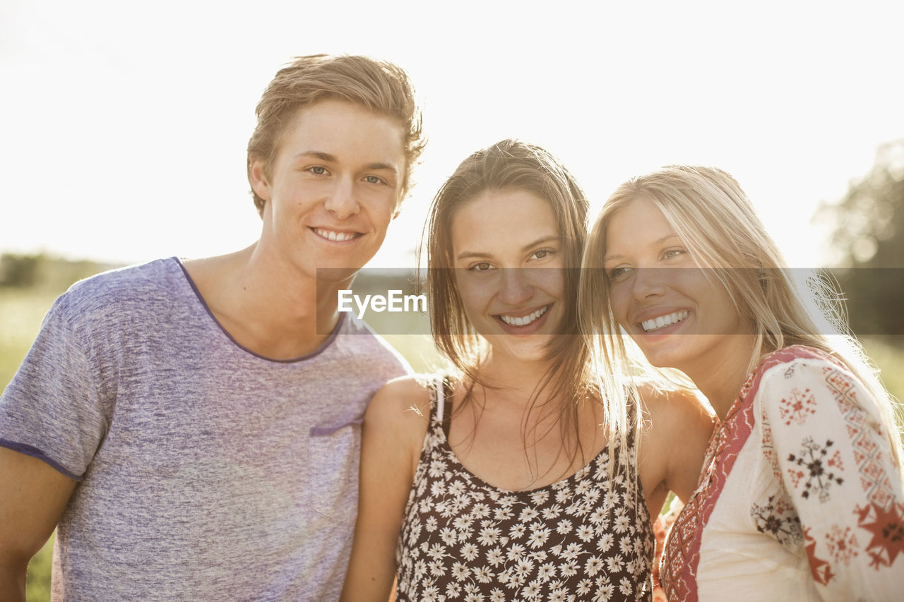 Portrait of young friends smiling outdoors