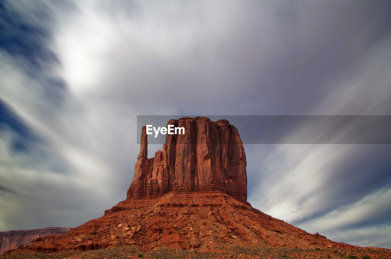 Low angle view of rock formation against sky