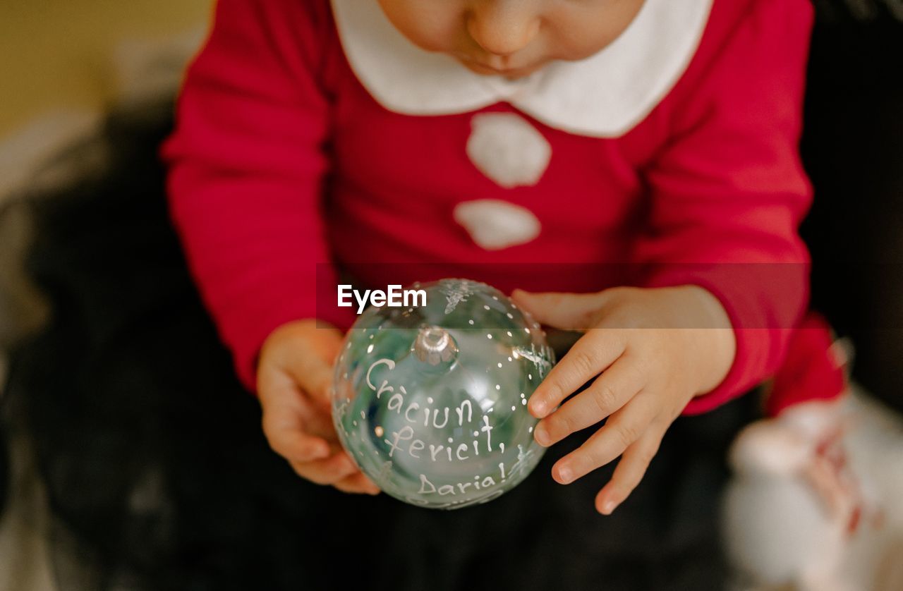 Close-up of hand holding christmas ornament 