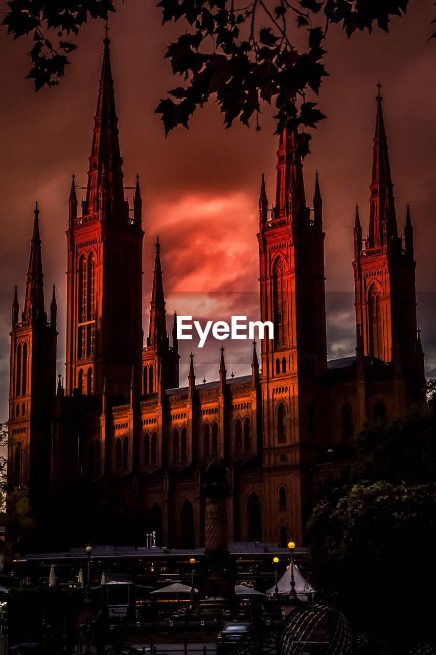 VIEW OF TEMPLE AGAINST BUILDINGS AT SUNSET