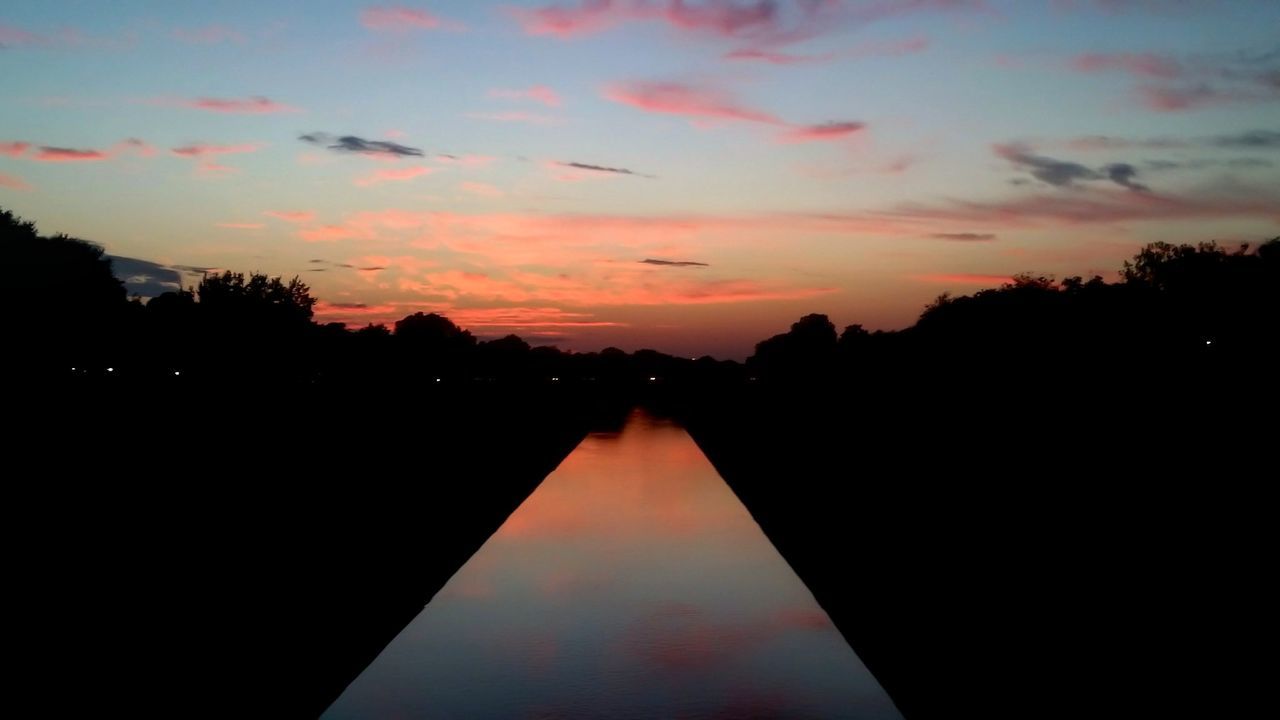 SILHOUETTE TREES BY LAKE AGAINST SKY AT SUNSET