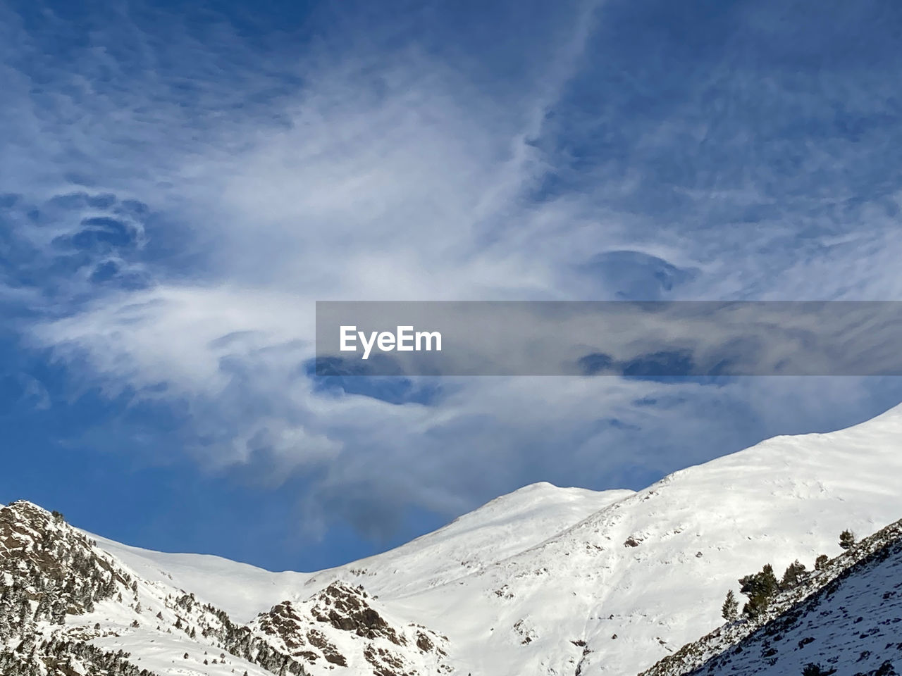 scenic view of snowcapped mountains against cloudy sky