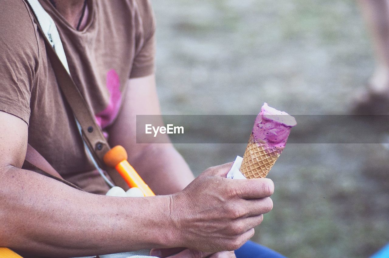 Mid-section of man with ice cream