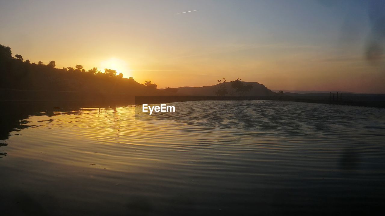 SCENIC VIEW OF LAKE DURING SUNSET