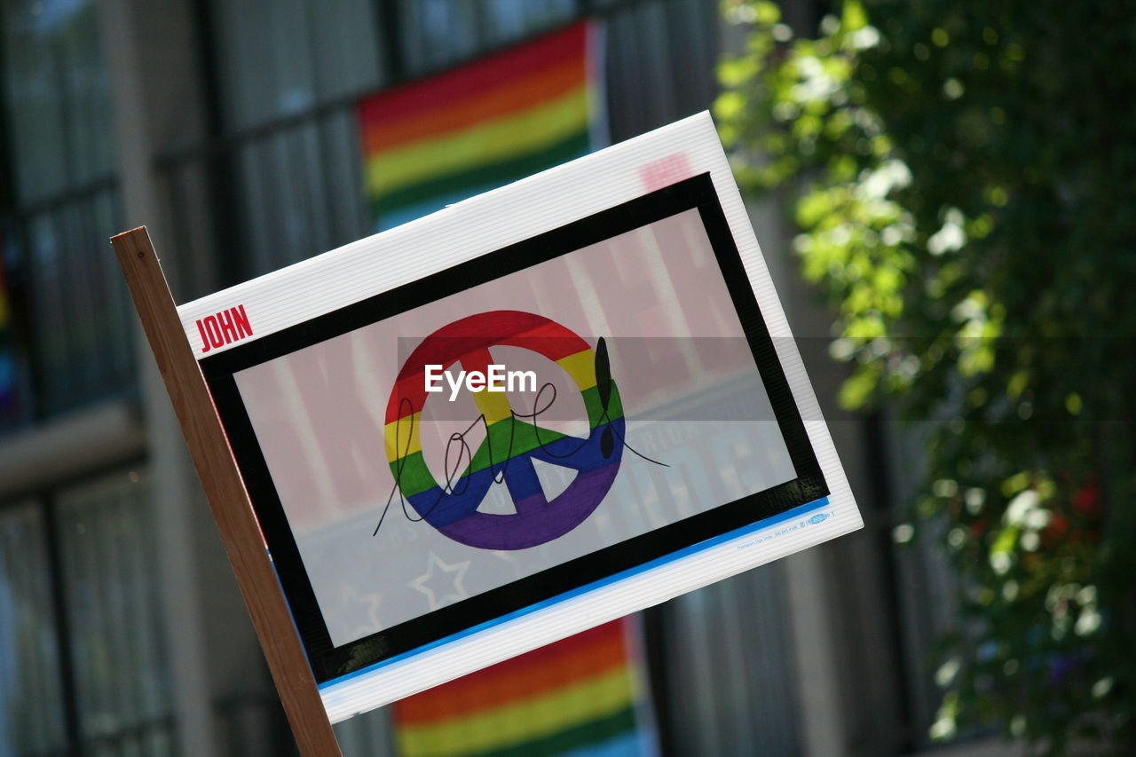 Close-up of peace symbol on banner during gay pride parade