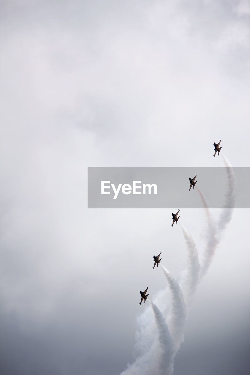 LOW ANGLE VIEW OF AIRPLANES IN SKY