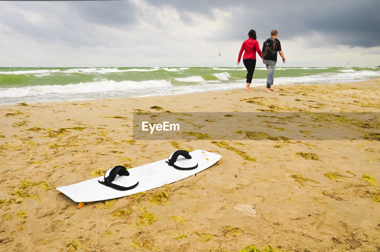 PEOPLE STANDING ON BEACH