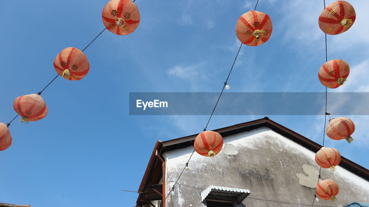 LOW ANGLE VIEW OF LANTERNS AGAINST SKY