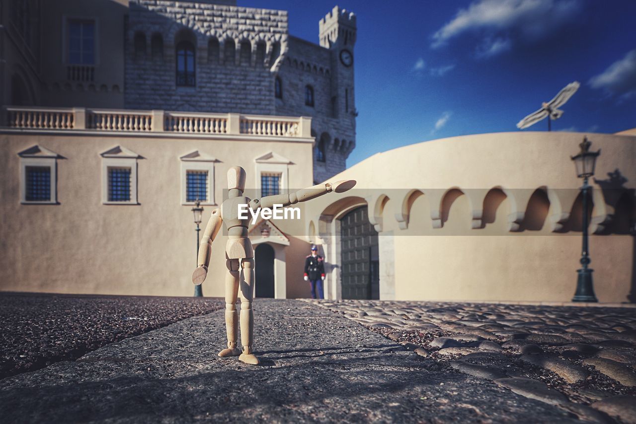 WOMAN STANDING IN FRONT OF BUILDINGS