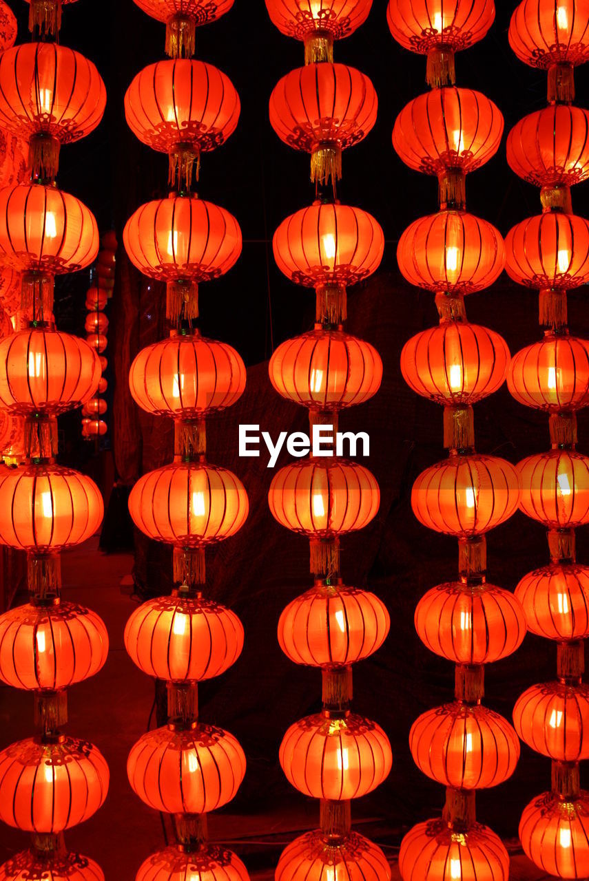 Full frame shot of illuminated lanterns hanging at night