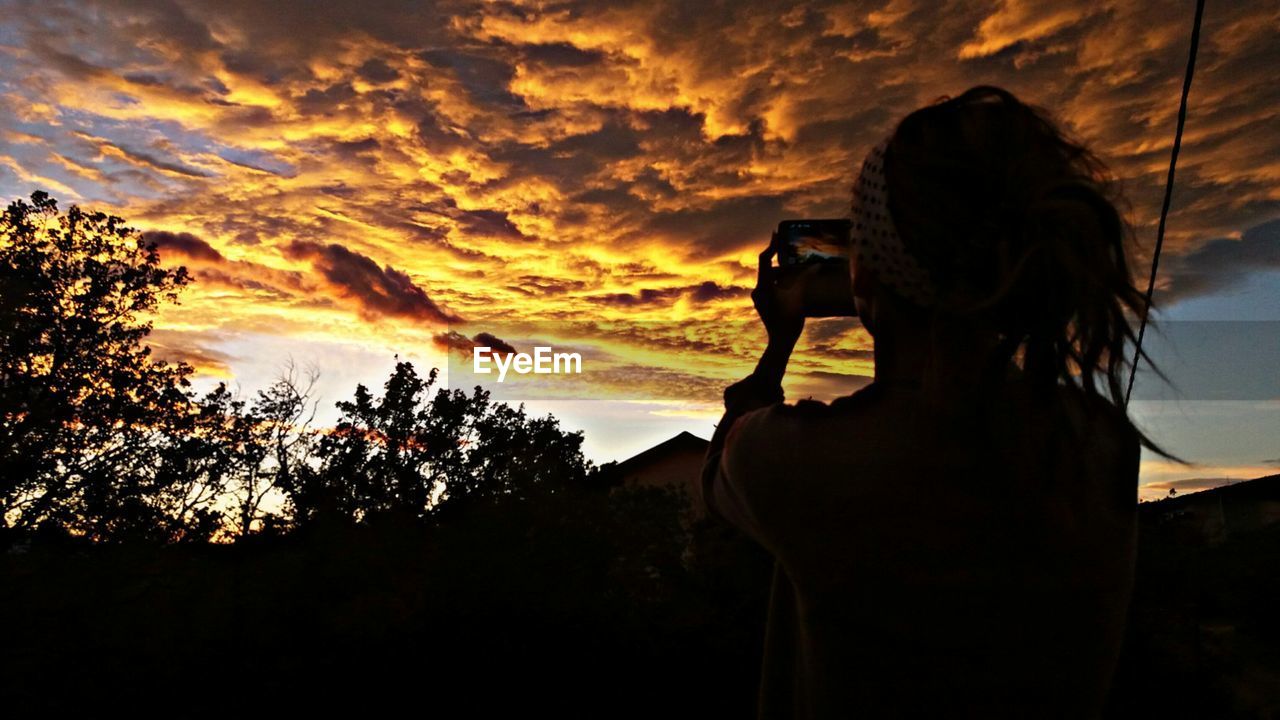 SILHOUETTE OF WOMAN AT SUNSET