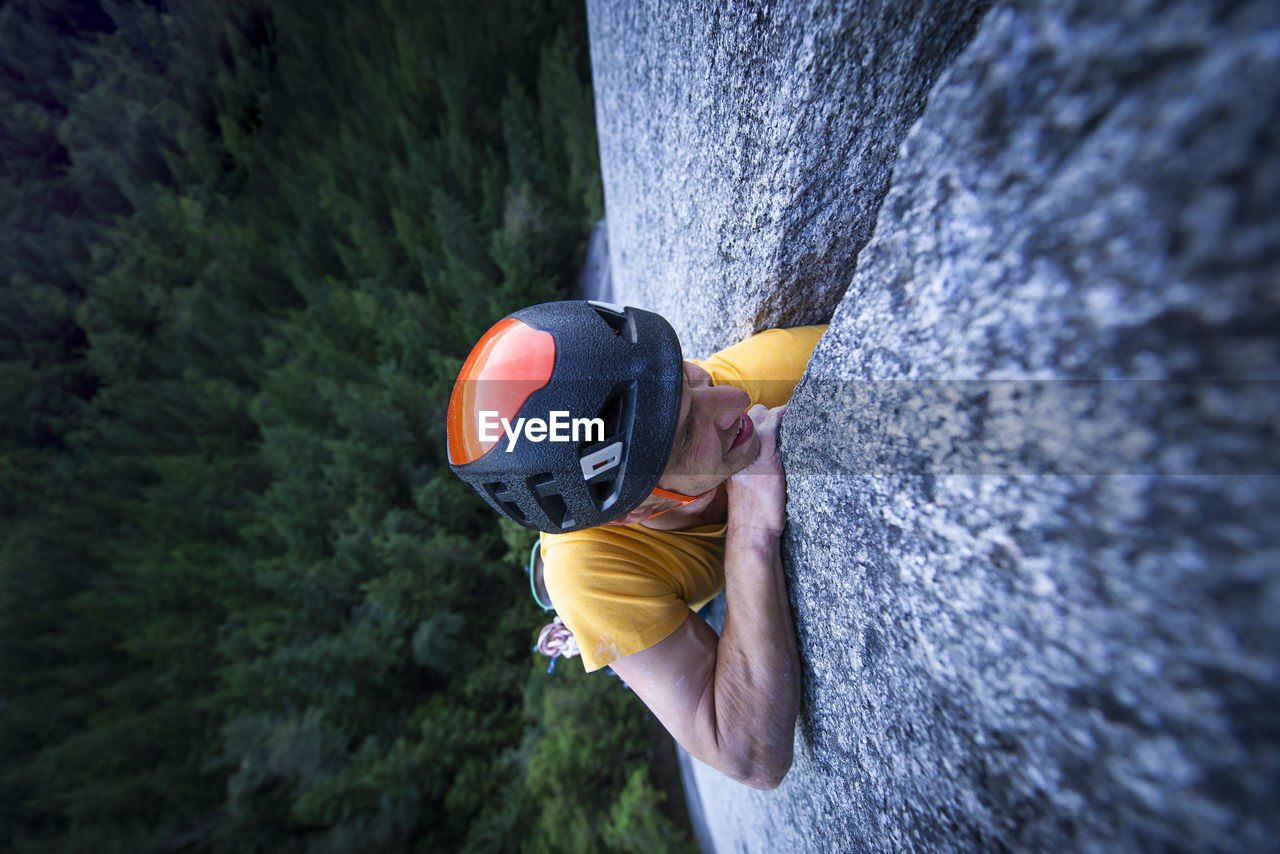 Man struggling lead climbing in off-width climb on granite squamish