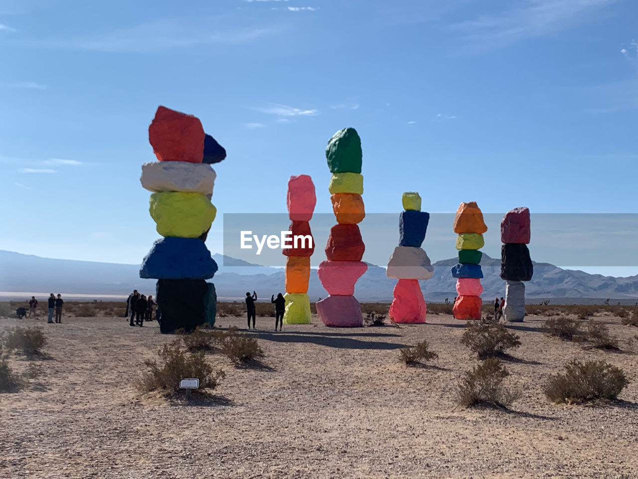 Stack of stones on desert against sky