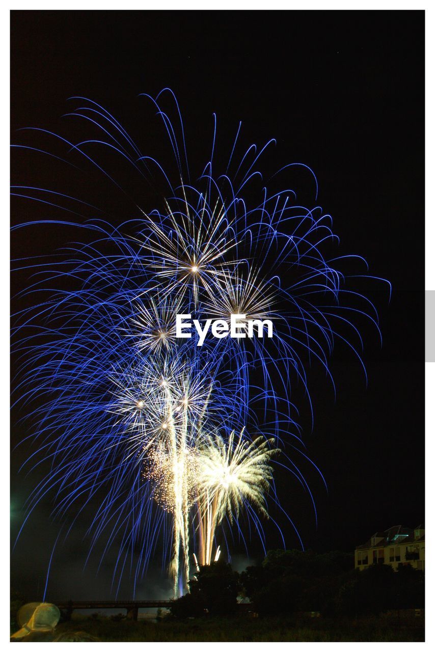 LOW ANGLE VIEW OF FIREWORKS IN SKY