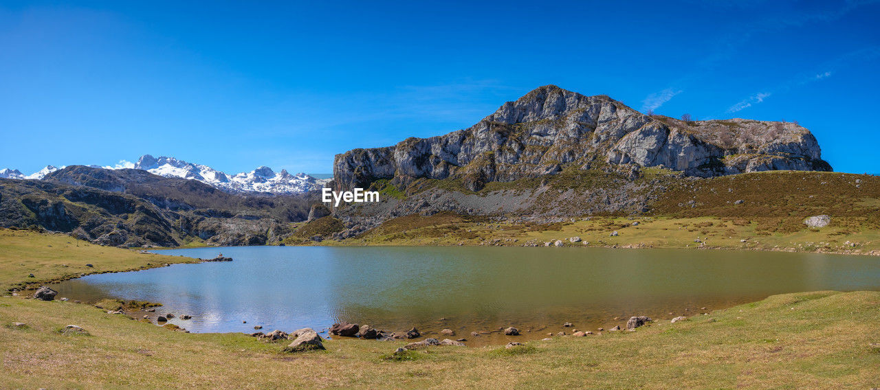 scenic view of lake and mountains against sky