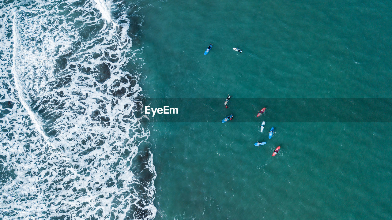 Group of surfers waiting to surf a wave