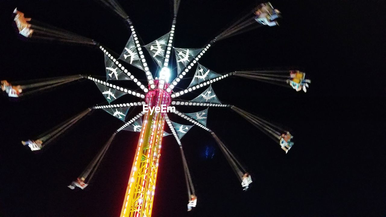 LOW ANGLE VIEW OF ILLUMINATED FERRIS WHEEL AGAINST SKY