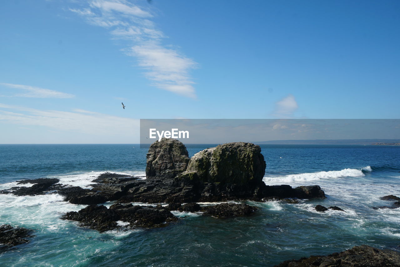 VIEW OF ROCK FORMATION ON BEACH AGAINST SKY