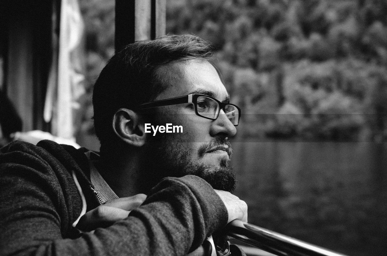 Man looking through window of vehicle