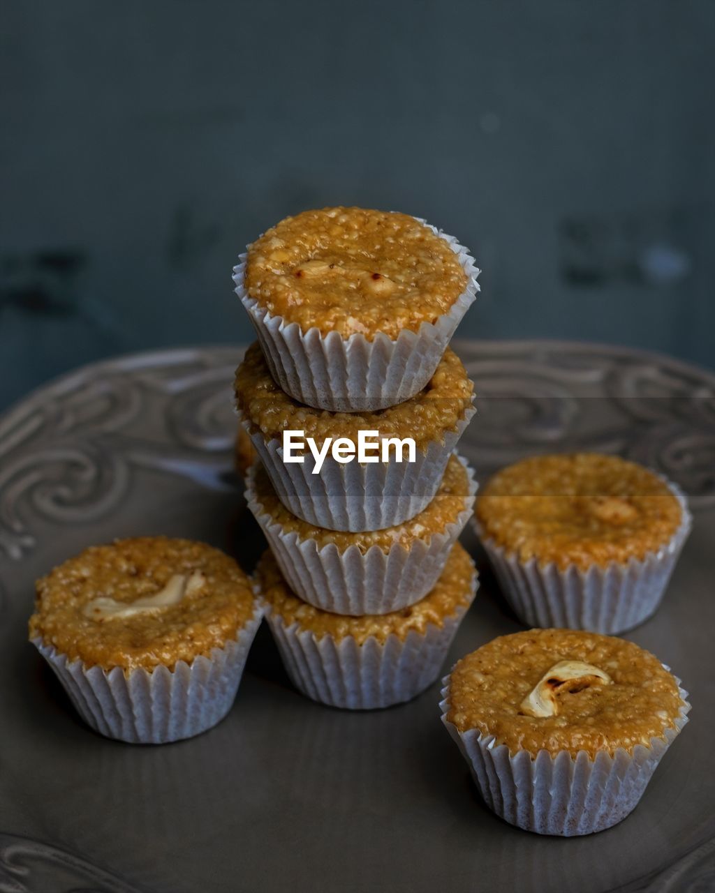 CLOSE-UP OF CUPCAKES ON TABLE AGAINST WALL