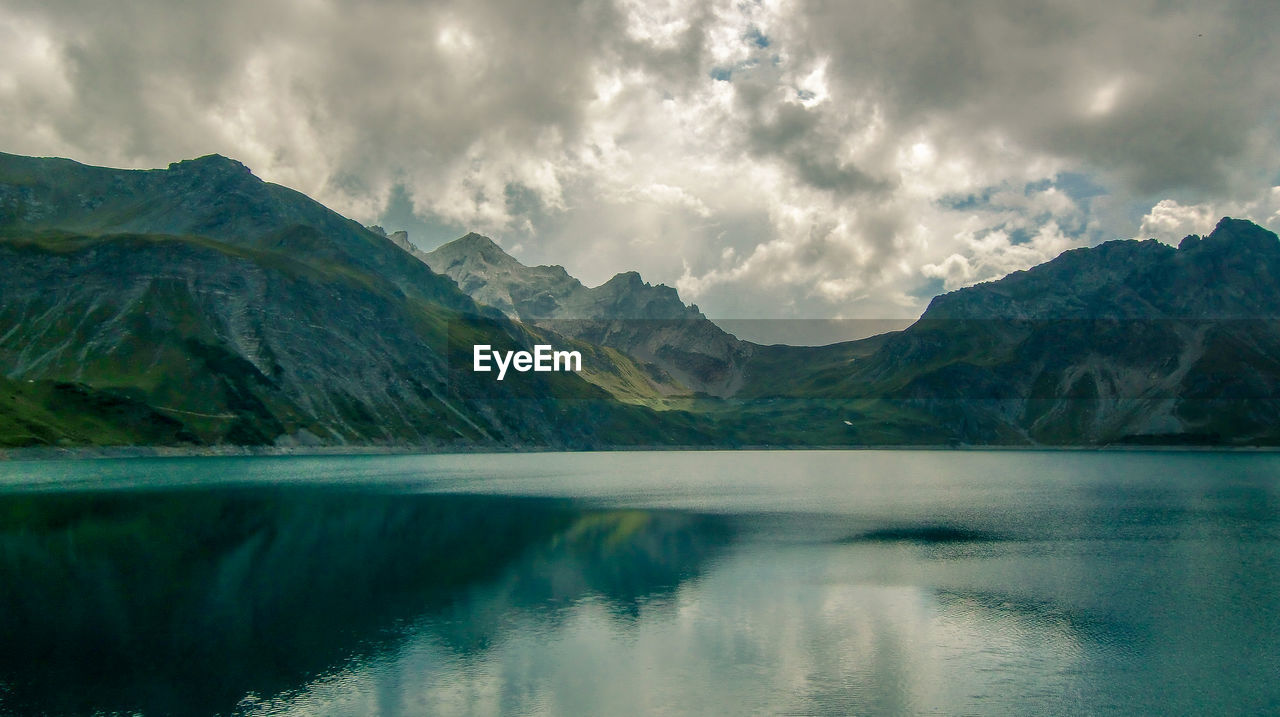 Scenic view of lake and mountains against sky