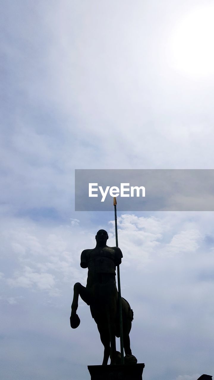 Low angle view of statue against sky