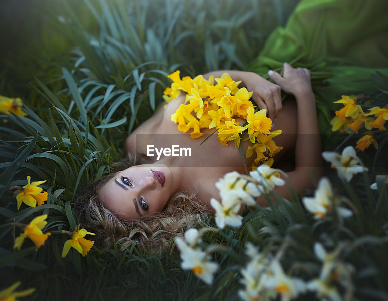 HIGH ANGLE VIEW OF WOMAN LYING DOWN ON YELLOW FLOWER