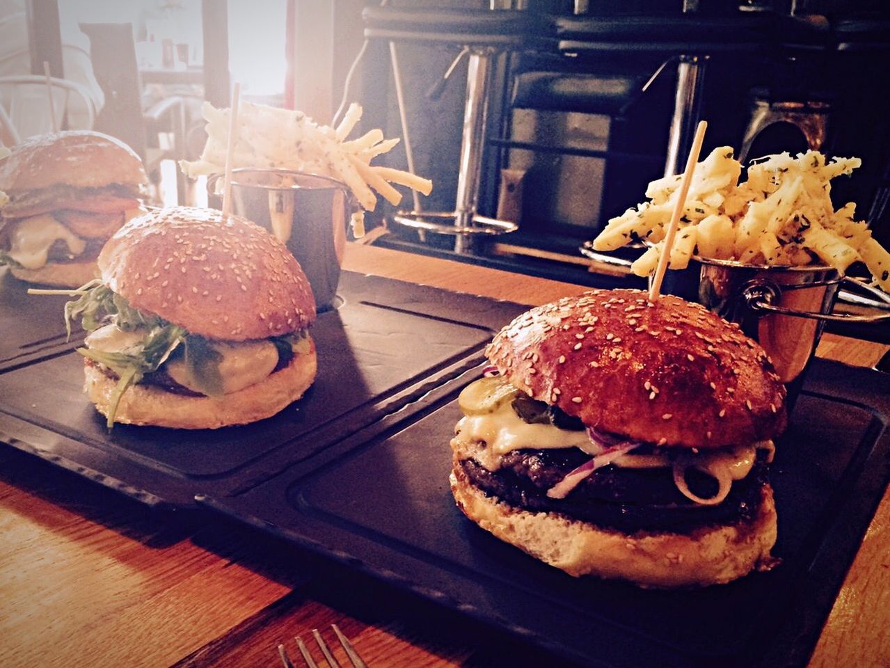 High angle view of burgers and french fries on table at restaurant