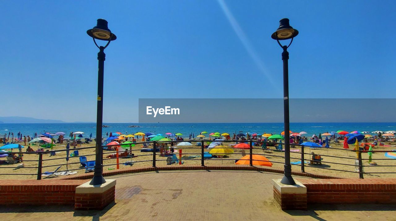 STREET LIGHTS ON BEACH AGAINST CLEAR SKY