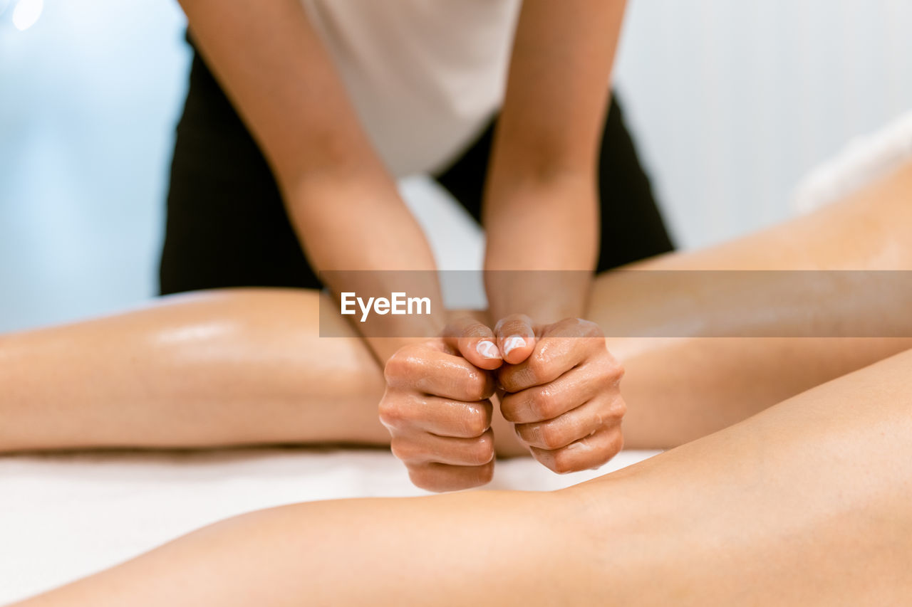 Massage therapist massaging woman at spa