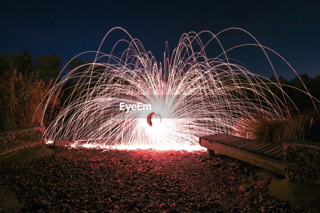 Light painting on field against sky at night