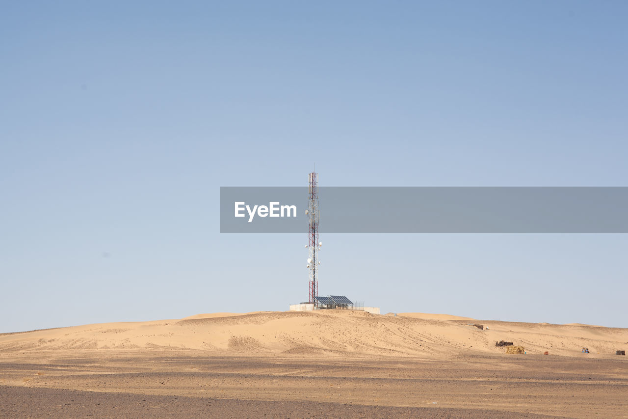 LOW ANGLE VIEW OF COMMUNICATIONS TOWER ON LAND