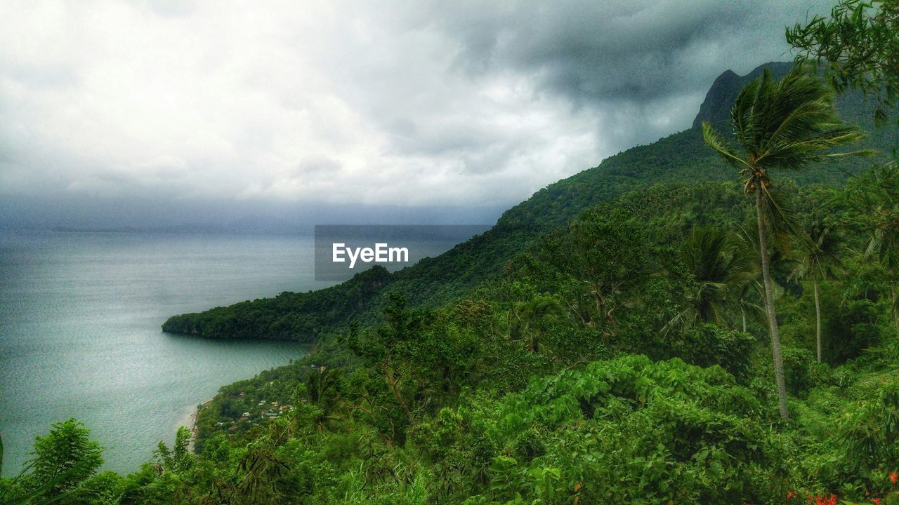 SCENIC VIEW OF SEA WITH MOUNTAINS IN BACKGROUND