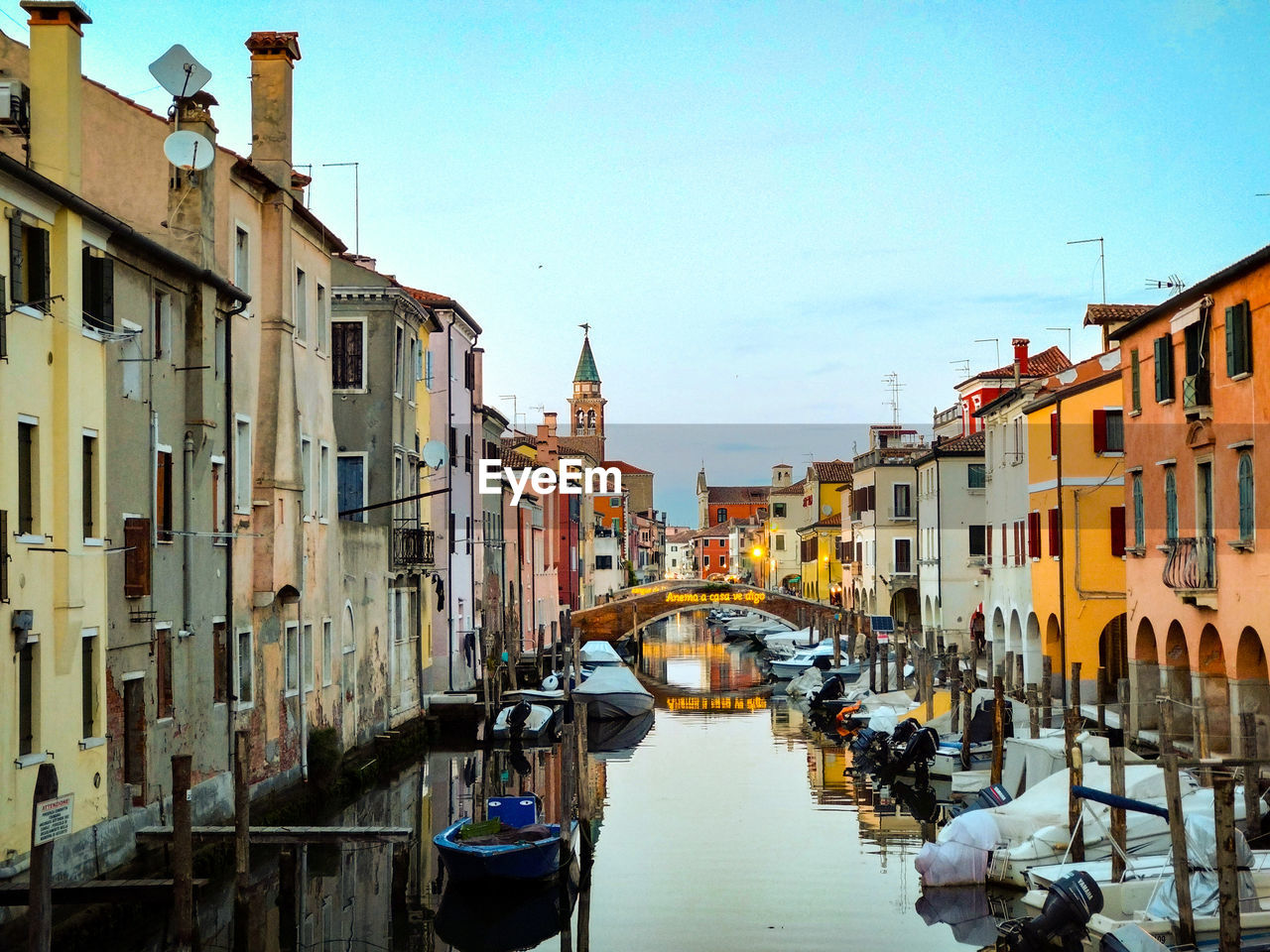 architecture, canal, building exterior, water, built structure, nautical vessel, gondola, transportation, travel destinations, waterway, city, mode of transportation, town, travel, nature, tourism, body of water, sky, building, boat, cityscape, vehicle, bridge, channel, watercraft, gondolier, clear sky, day, residential district, outdoors, trip, vacation, moored, holiday, no people, waterfront, old, reflection, sunlight