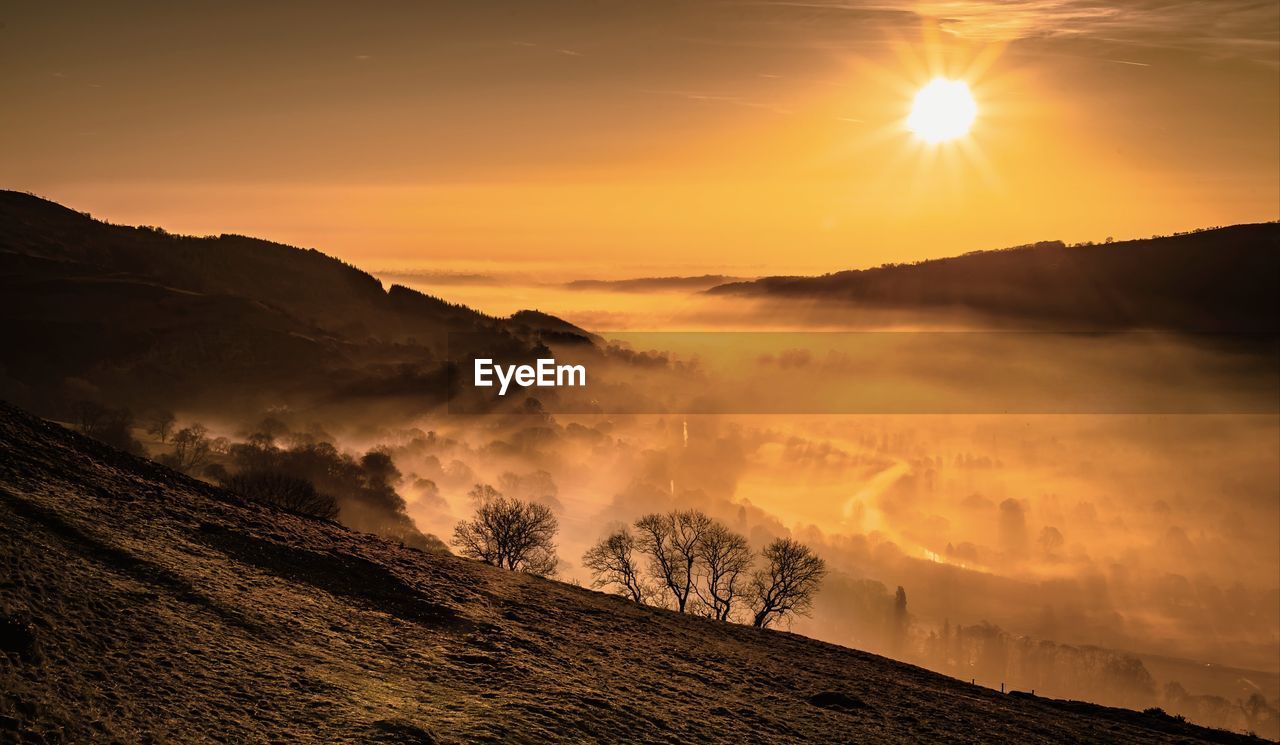 Scenic view of landscape against sky during sunset