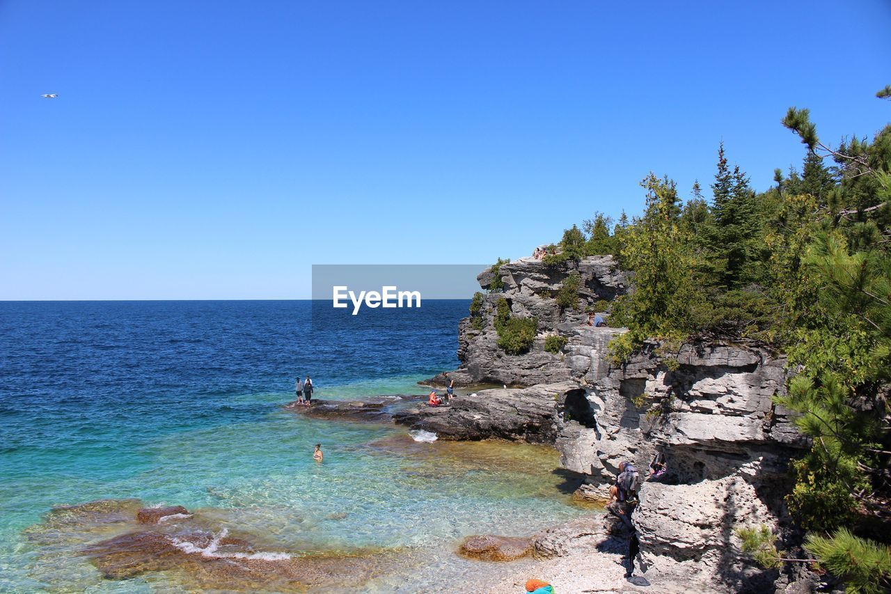 Scenic view of sea against clear blue sky